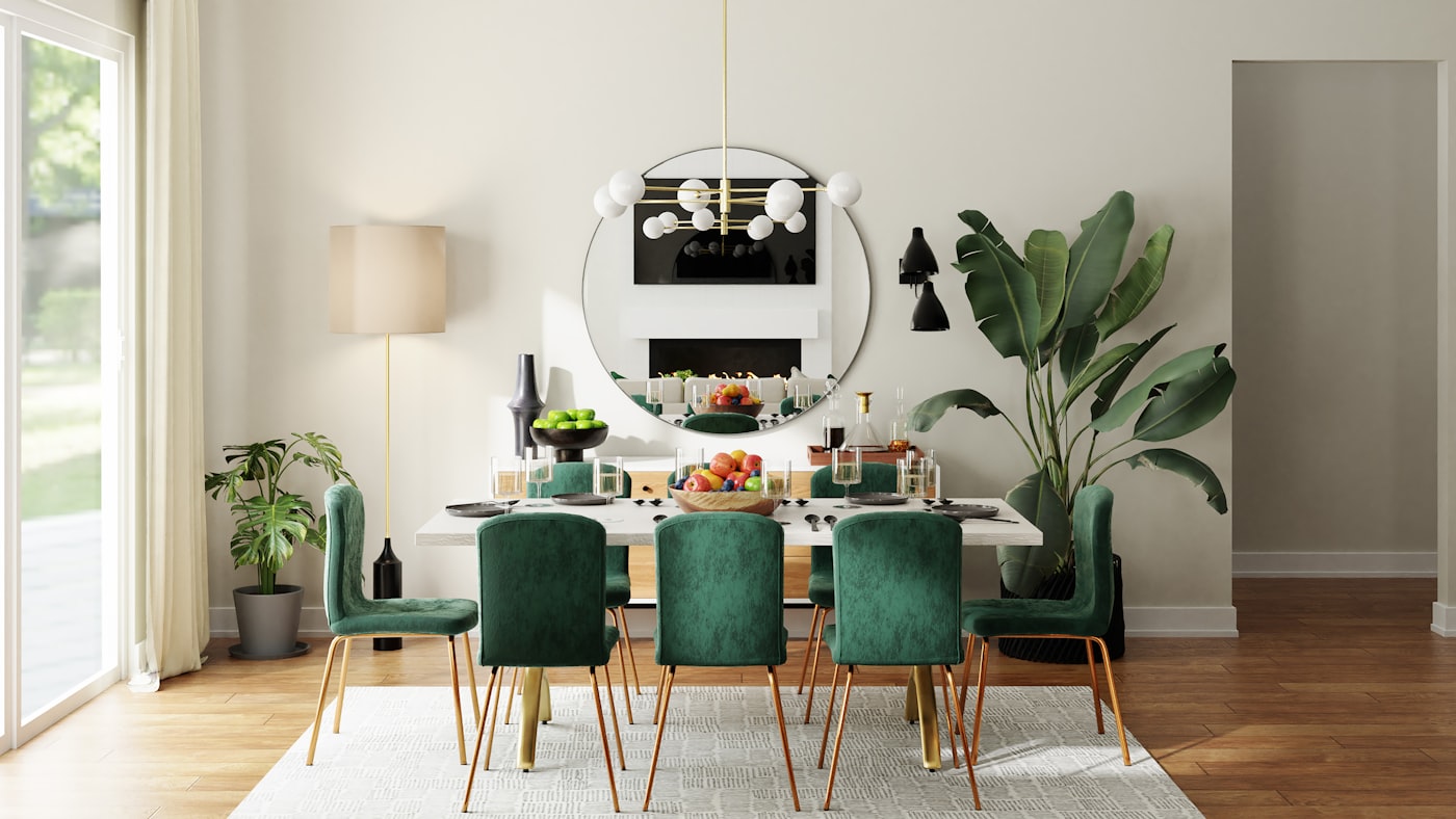 A modern dining room with a marble table and green velvet chairs